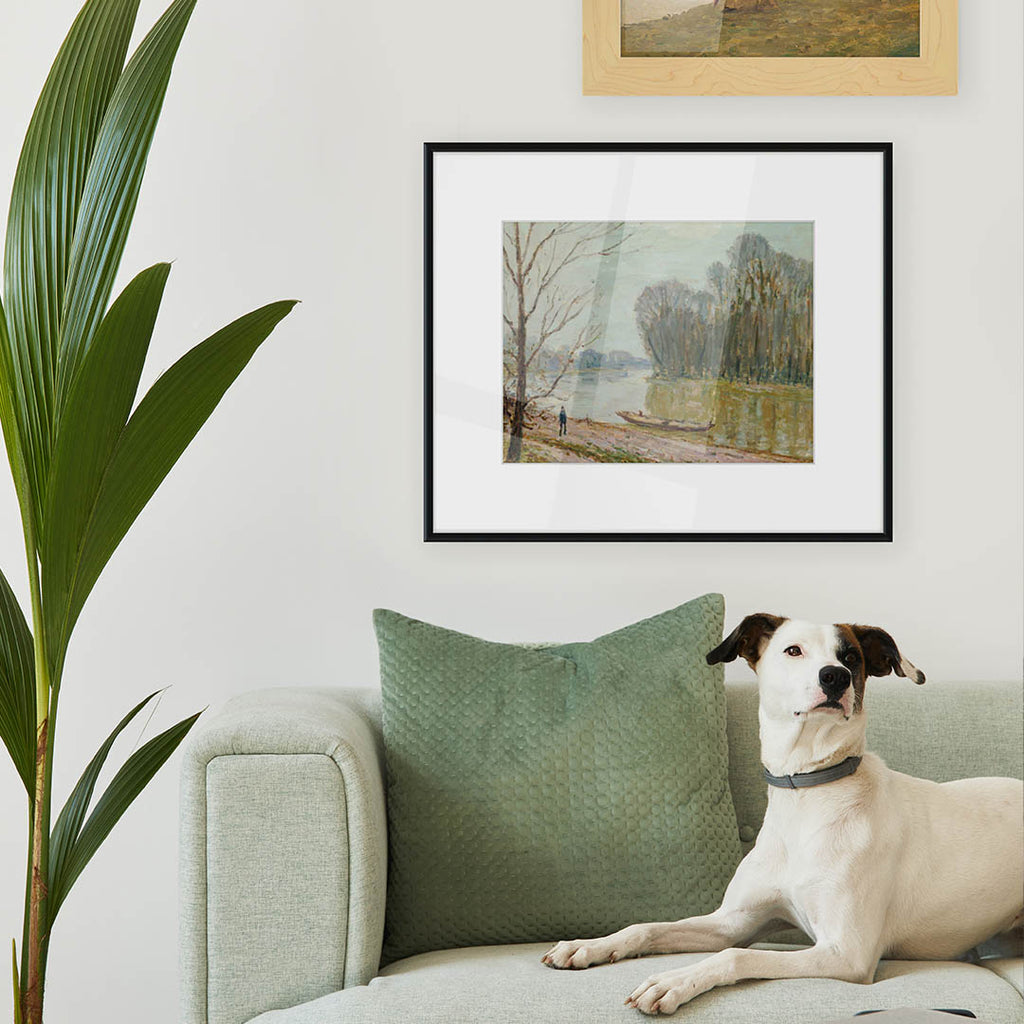 bright living room with a dog on green couch and an oak and robin gallery wall